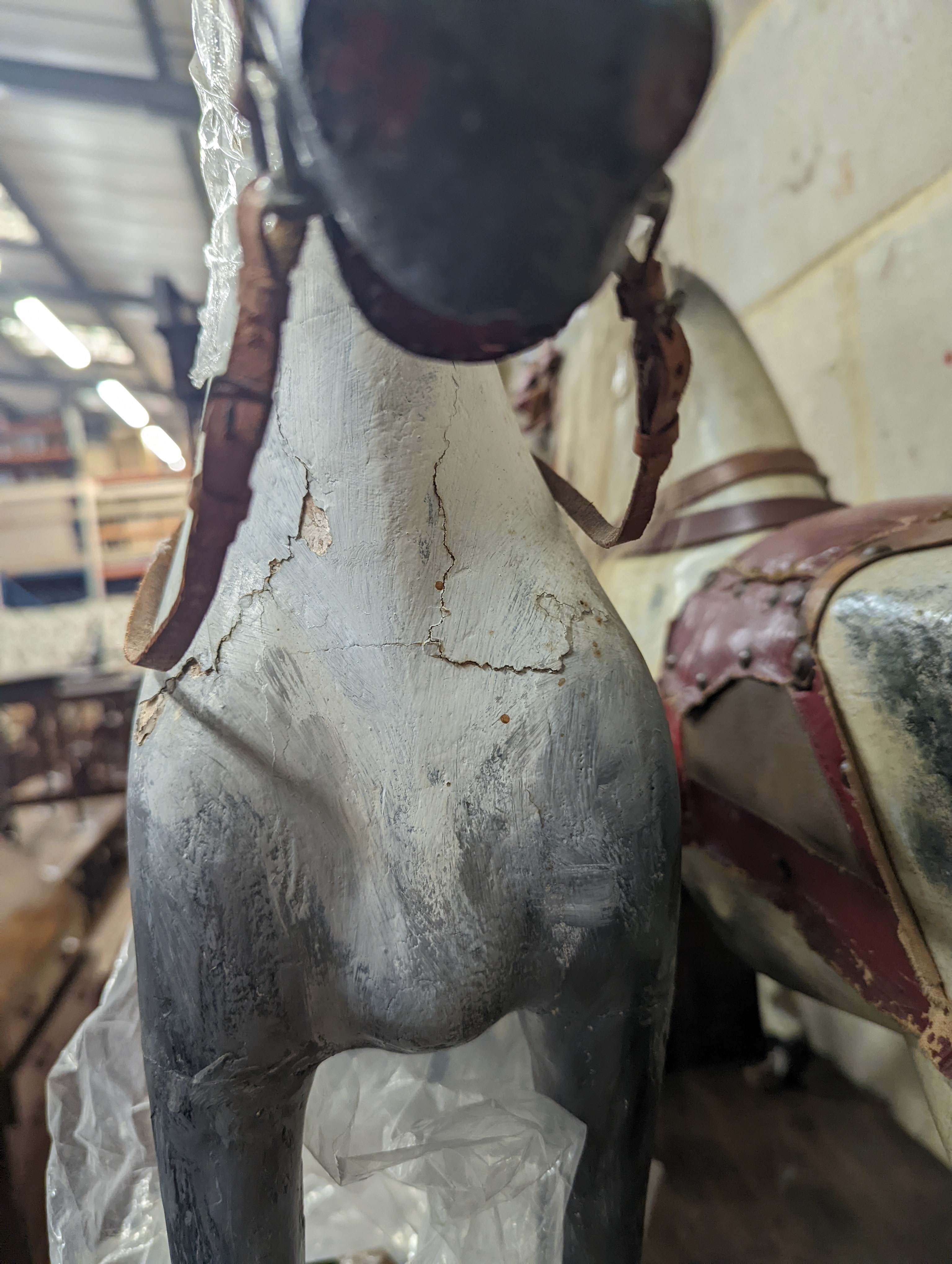 A Victorian carved and painted wood rocking horse, lacking underframe, length 77cm and two painted wood hobby horses, 58cm and 38cm